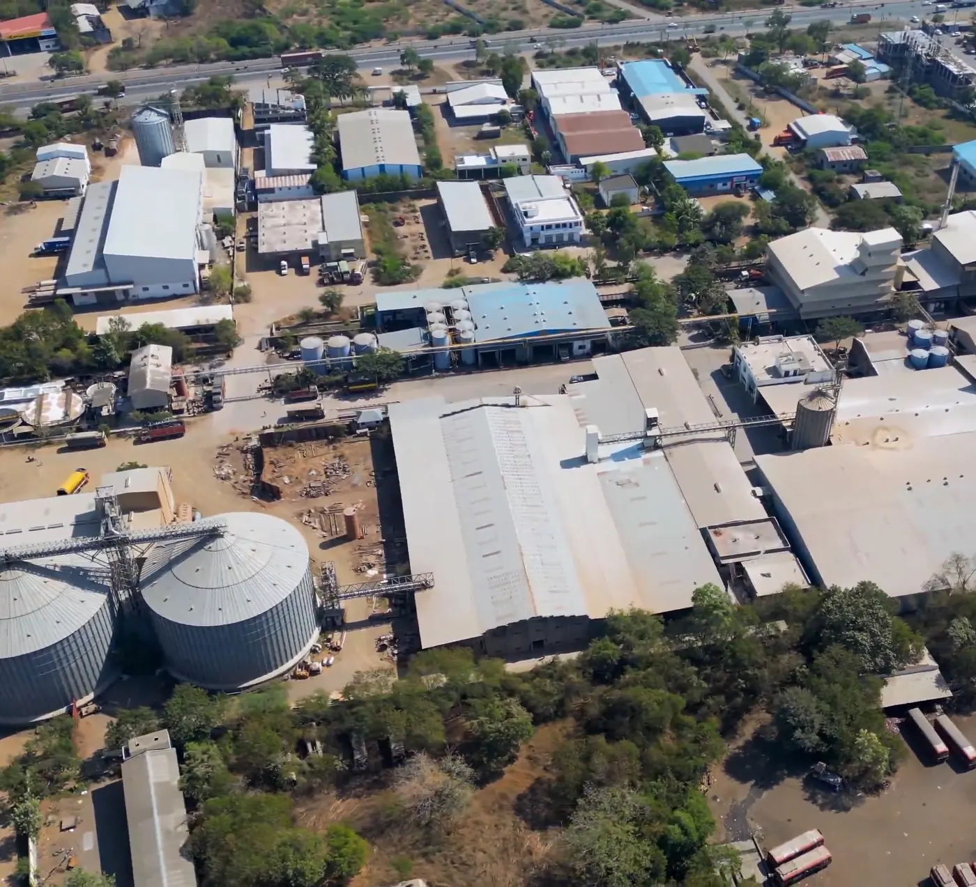 Aerial view of MOEL's Dhule plant with its two grain silos and processing sheds